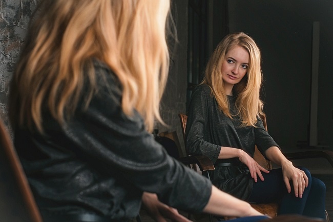 Business woman looking in the mirror